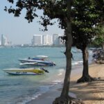 A picture of a beach with boats in water