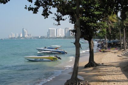 A picture of a beach with boats in water