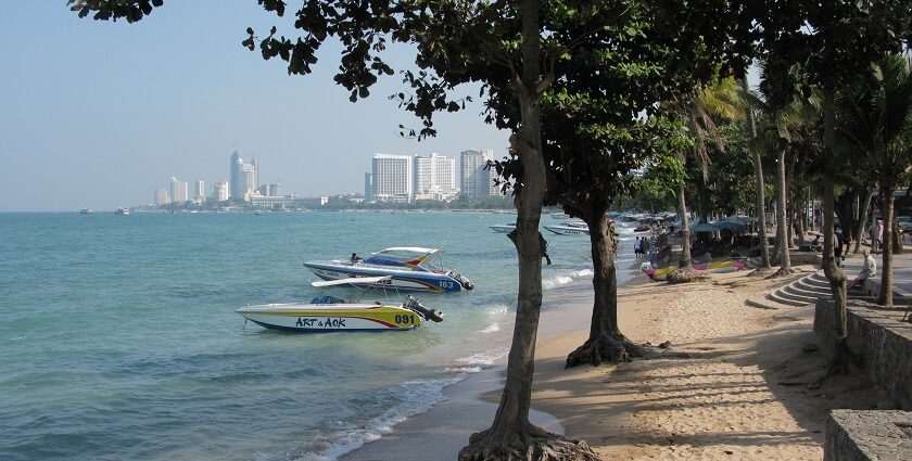 A picture of a beach with boats in water