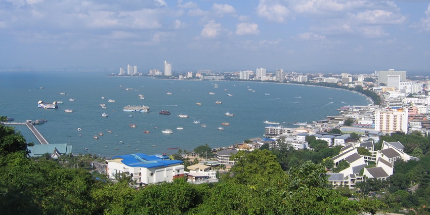 Pattaya Beach from a viewpoint, displaying sandy shores and vibrant cityscape beyond.