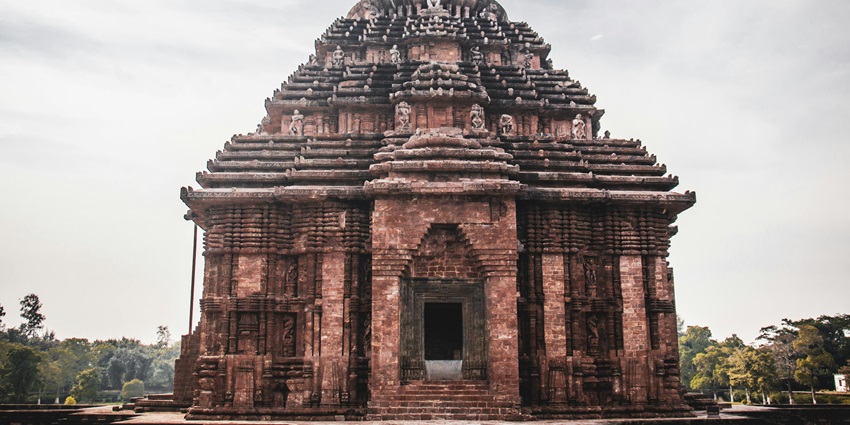 Close-up view of an ancient Hindu temple facade with detailed ornamental decor, stone carvings, and sacred symbols, one of the best things to see in Dalhousie in October.