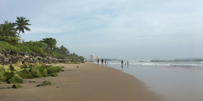 A glimpse of shimmering waters meeting the golden sands at the Payyambalam Beach.