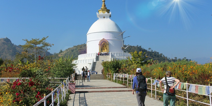 Beautiful white peace pagoda surrounded by lush greenery - places to visit in Namsai