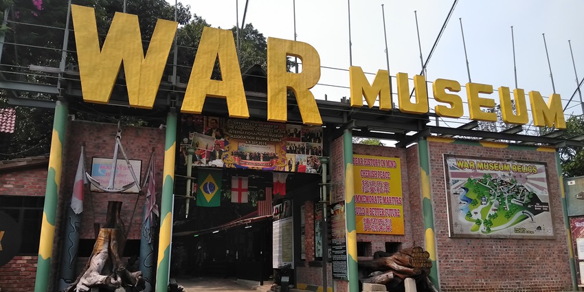 Exterior of Penang War Museum showing bunker ruins and dense tropical greenery