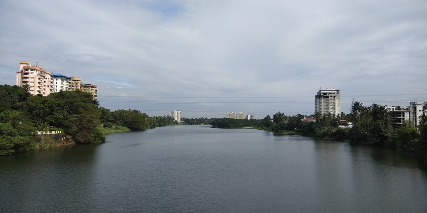 A scenic view of a river in Kerala with majestic blue waters and verdant river banks