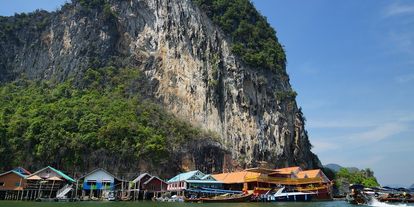 A scenic view of colourful houses constructed over water at the Phang Nga Bay in Thailand