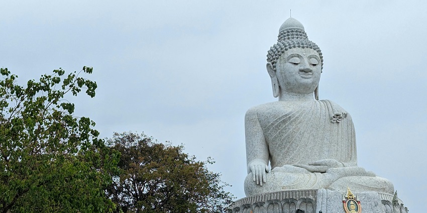 A statue of Buddha at Phetchaburi, one of the best places to visit in Thailand in August.