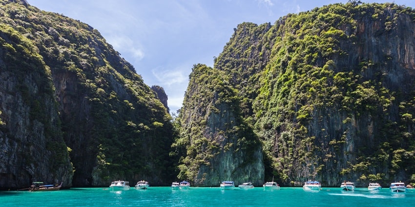 Numerous ferries sailing in the beautiful turquoise water near the Phi Phi island