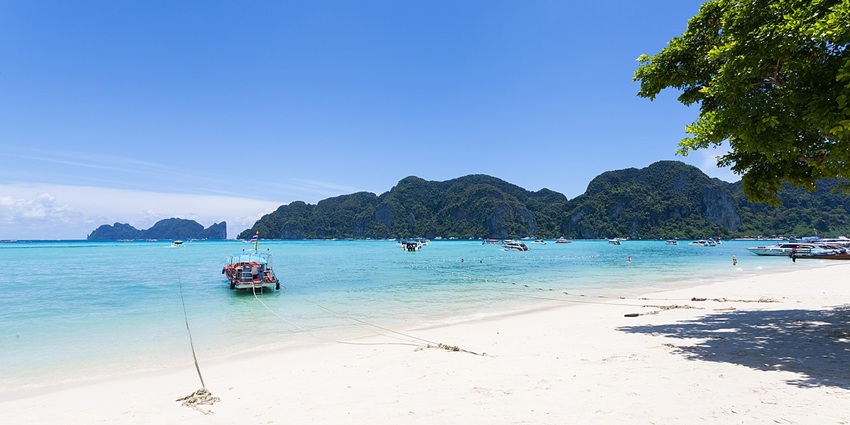 A scenic view of Ko Phi Phi Don's turquoise waters and limestone cliffs, Thailand.