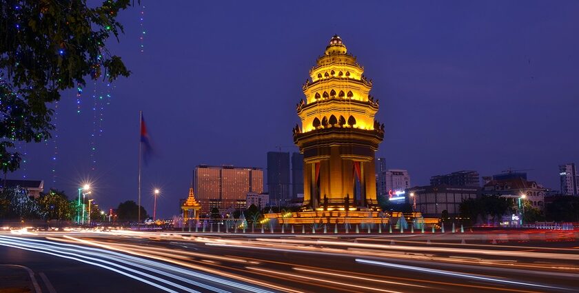 A breathtaking view of a city with a monument covered in yellow lights during the night.