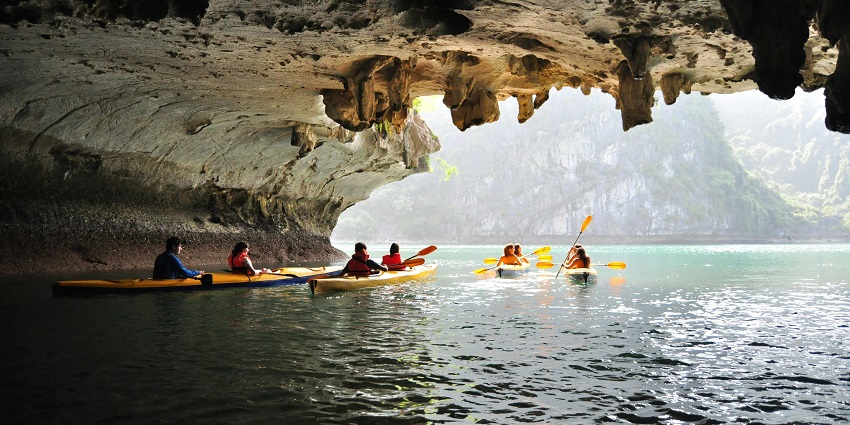 Group of people on kayaks, paddling together in a scenic waterway adventures.