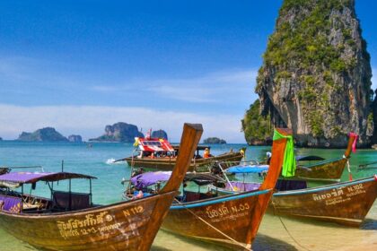 A view of boats lined up on the seashore of picturesque Phra Nang Beach in Thailand.