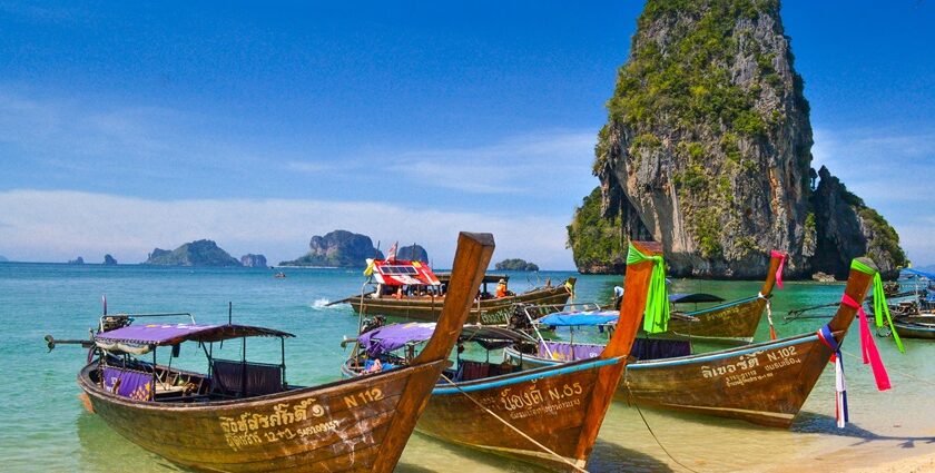 A view of boats lined up on the seashore of picturesque Phra Nang Beach in Thailand.