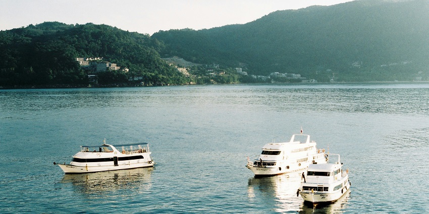 Ships on serene waters of Phuket, one of the top places to visit in Thailand for couples.
