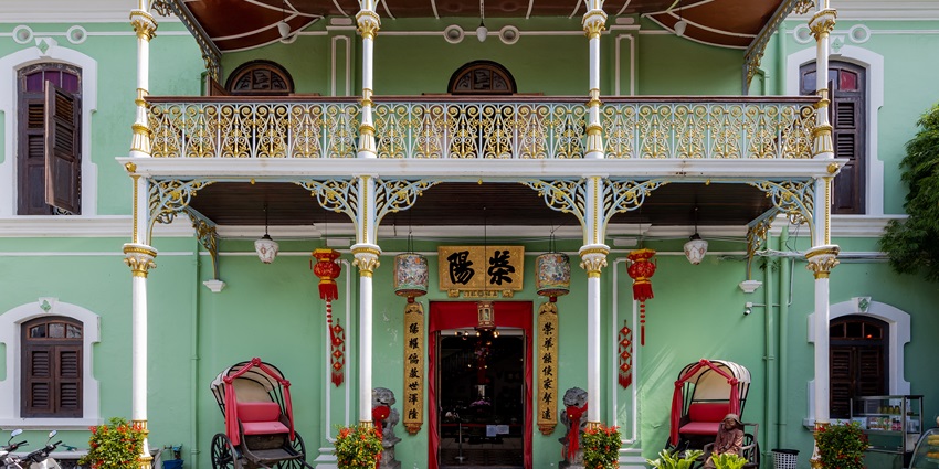 Front view of Pinang Peranakan Mansion with green windows and ornate design–places to visit in penang