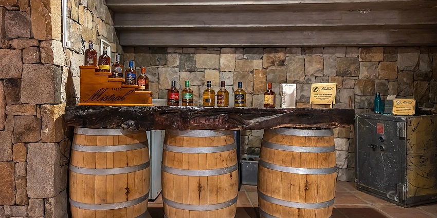Barrels of alcohol placed under a Bar counter