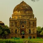 A stunning view of a historical monument surrounded by lush green trees during the day.