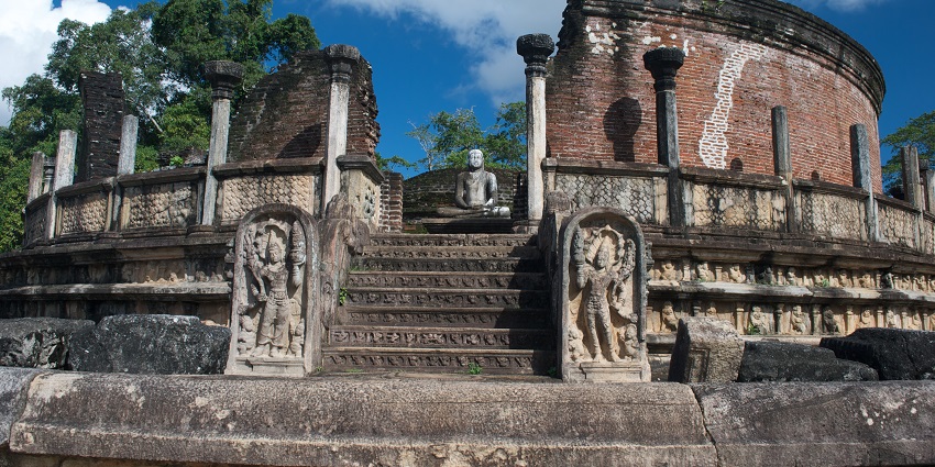 Ancient stone structure in Polonnaruwa, Sri Lanka, featuring intricate carvings.