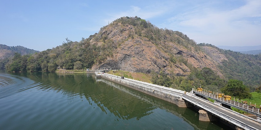 Ponmudi Dam in Idukki, Kerala, showcasing its concrete gravity structure and tranquil reservoir.