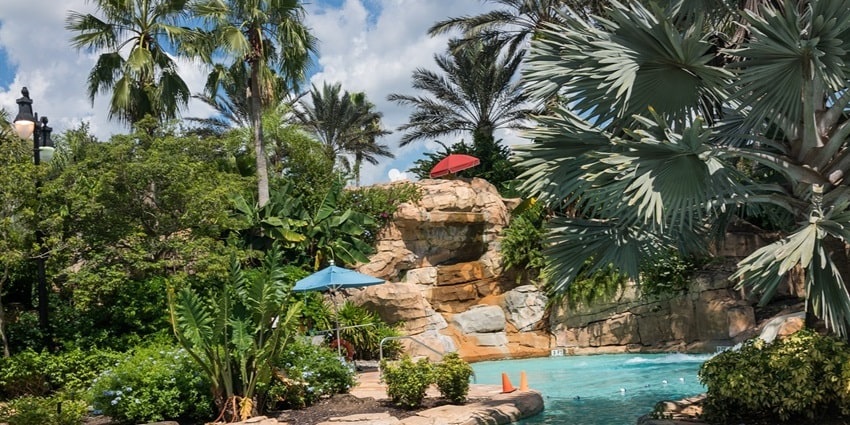 beautiful snapshot of the pool and the water ride amidst the green setting of lush trees