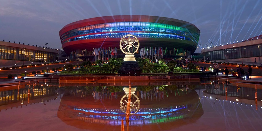 An evening with illuminated dome and surrounding modern architecture.