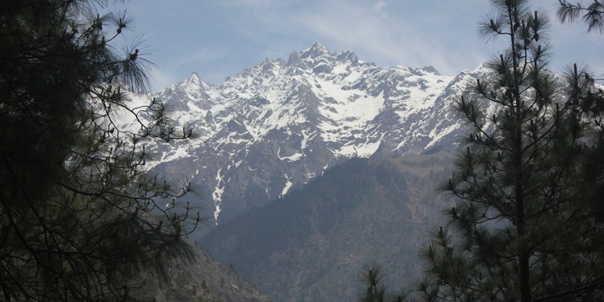The scenic snapshot of the snow-laden Himalayas from the Parvati Valley, Himachal