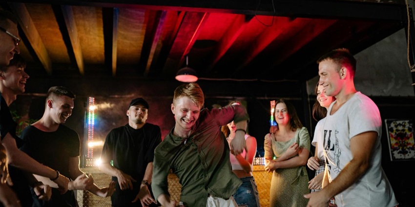 A group of people dancing at a pub
