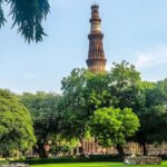 A picture of Qutub Minar showing the majestic tower and nearby attractions