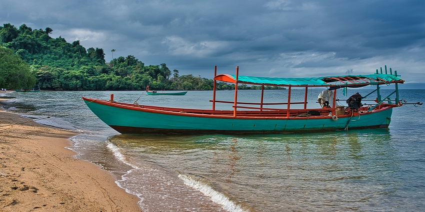A scenic view of a boat resting on the golden shorelines of Rabbit Island in Sri Lanka.