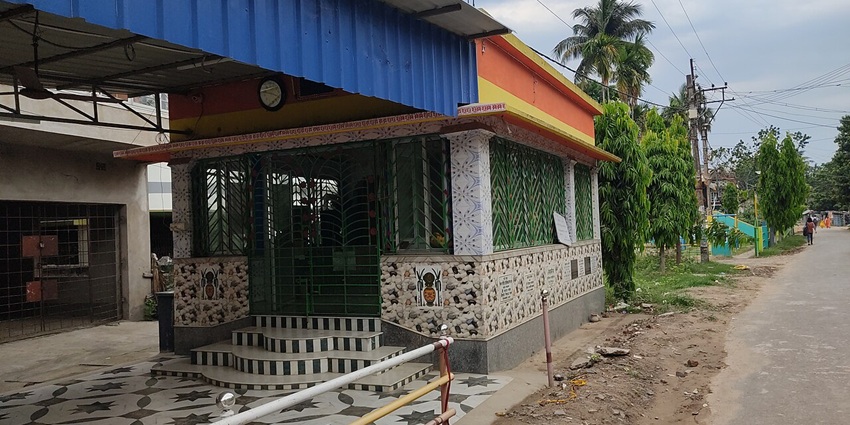 A frontal view of a temple complex, which is one of the best places to visit in Dibrugarh, with an idol of a goddess