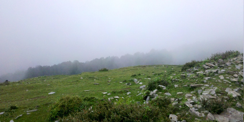 A mountain with a misty weather during daytime