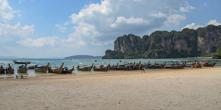 Boats decked on the seashore of Railay Beach, one of the best beaches in Thailand.