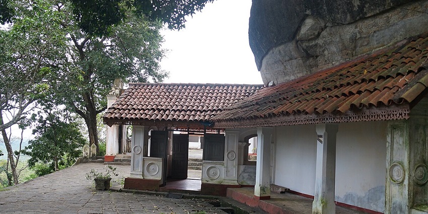 View of Mulkirigala Rock Temple, showcasing ancient architecture and lush greenery.