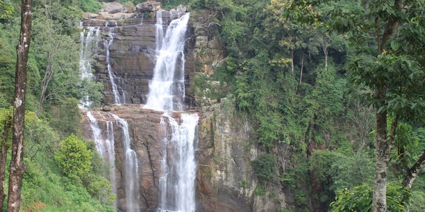 Ramboda Waterfalls cascading through lush greenery, a serene site in Sri Lanka.