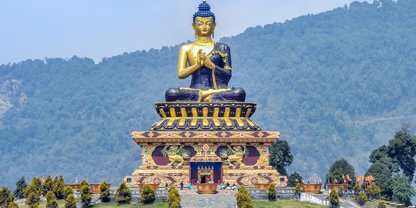 Witness the vibrant Buddha statue at this park with the magnificent Himalayas far behind