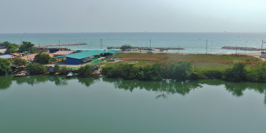 A scenic view of the tranquil waters of Rayong, surrounding a small village in the region.