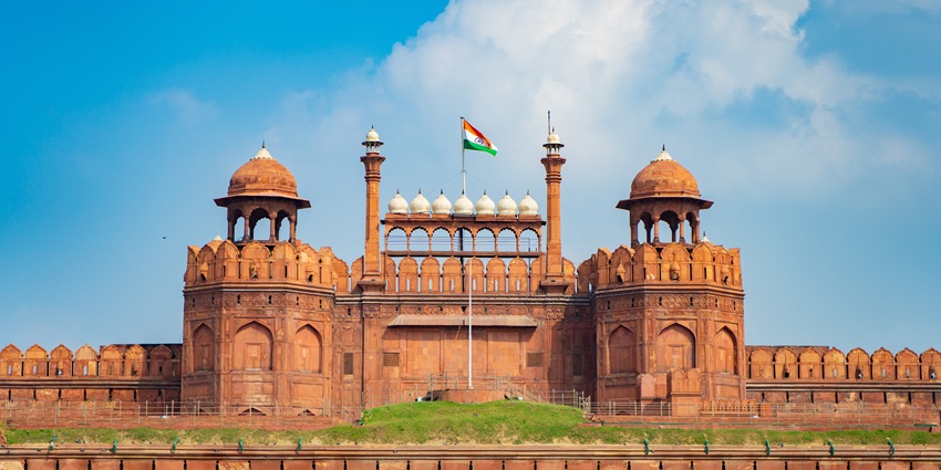 A breathtaking view of India Gate under dense clouds during the daytime to explore.