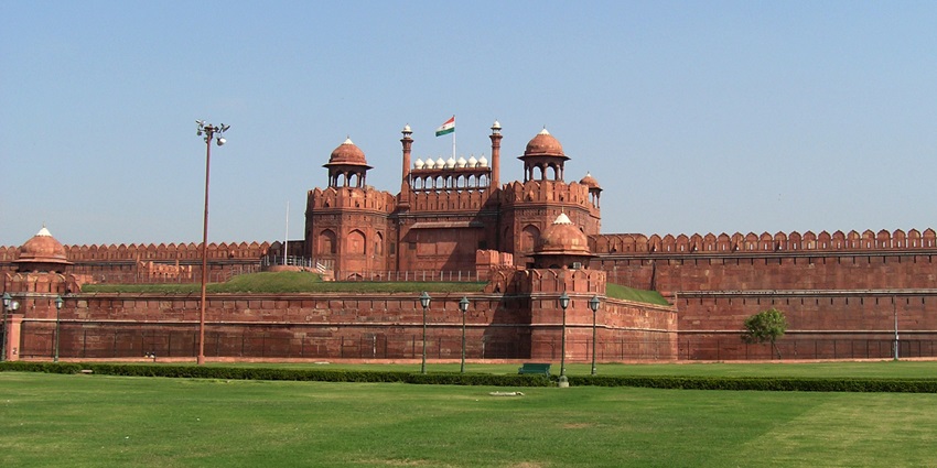 Clear view of the beautiful Red Fort and the National Flag waving on the top of it.