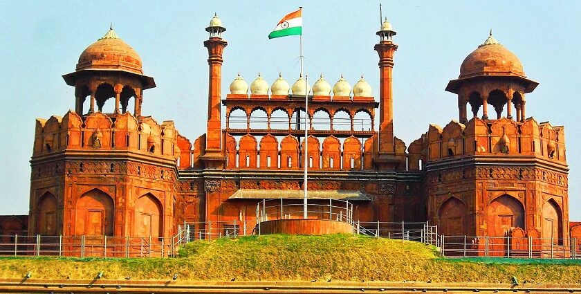 A frontal view of the Red Fort in Delhi with a garden in front