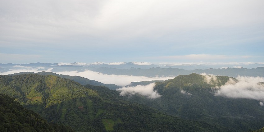 A stunning view from a hill top in Mizoram under dense clouds during the daytime.