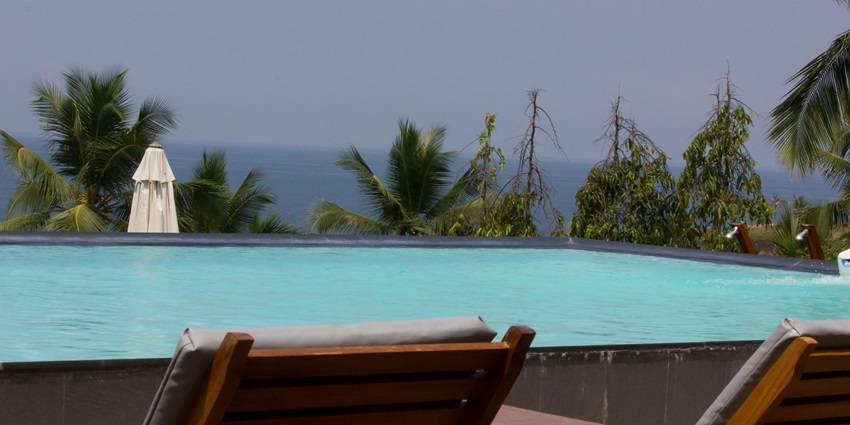 A picture of a swimming pool at a beachside resort in Chirala with the sea in background