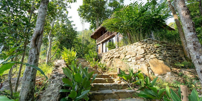Beautiful image of a resort in the hills of lush green mountains of the Himalaya