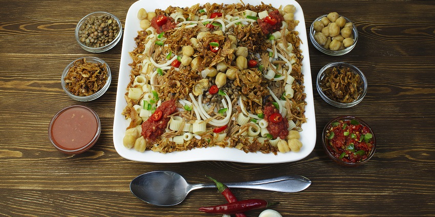 A plate of traditional Egyptian dish Koshary, served with various ingredients.