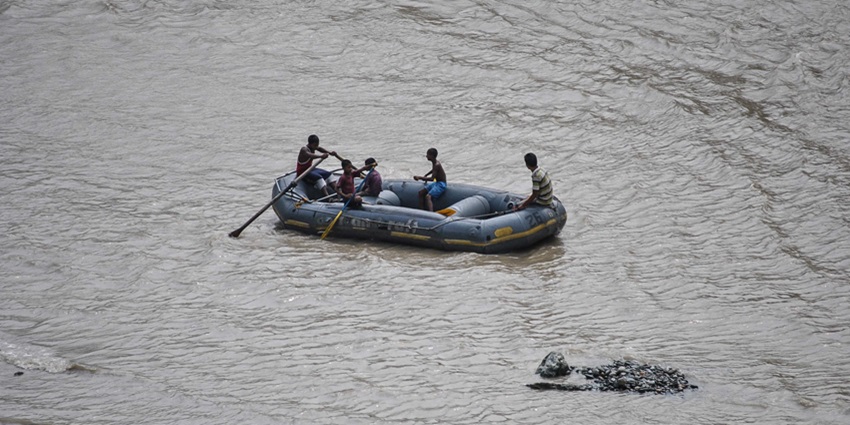 People rafting through a fast-paced river