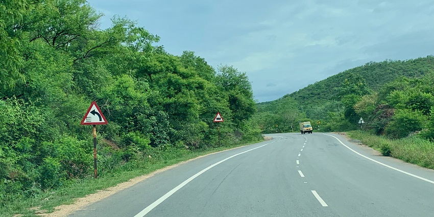 Road and the highway passing through a lush forest of Andhra pradesh near Pedakakni village