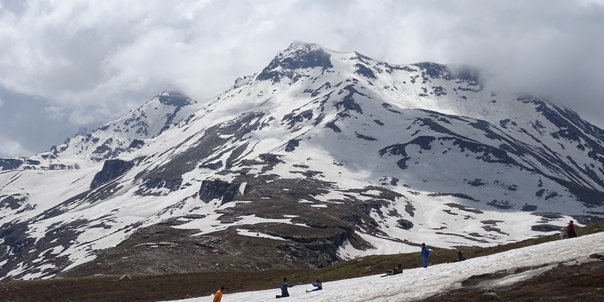 Tourists sleighing down the majestic snow clad mountains of Rohtang pass