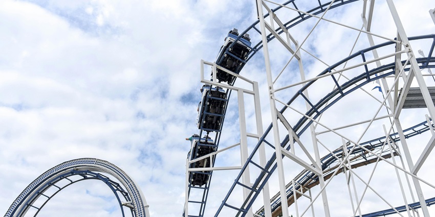 Roller coaster with thrilling loops and steep drops, offering an exciting ride - theme parks
