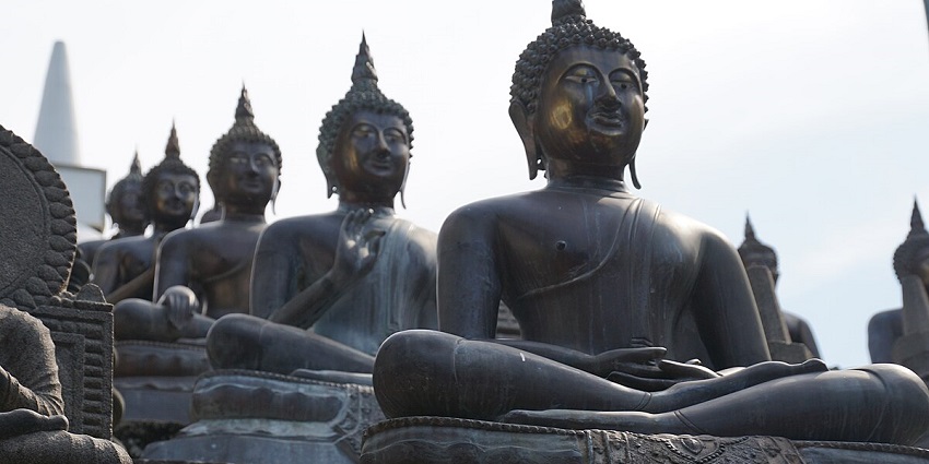 Rows of serene Buddha statues at Gangaramaya Temple, showcasing intricate details.