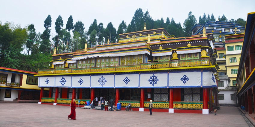 Rumtek monastery , with traditional surroundings, has an impressive golden roof shining bright.