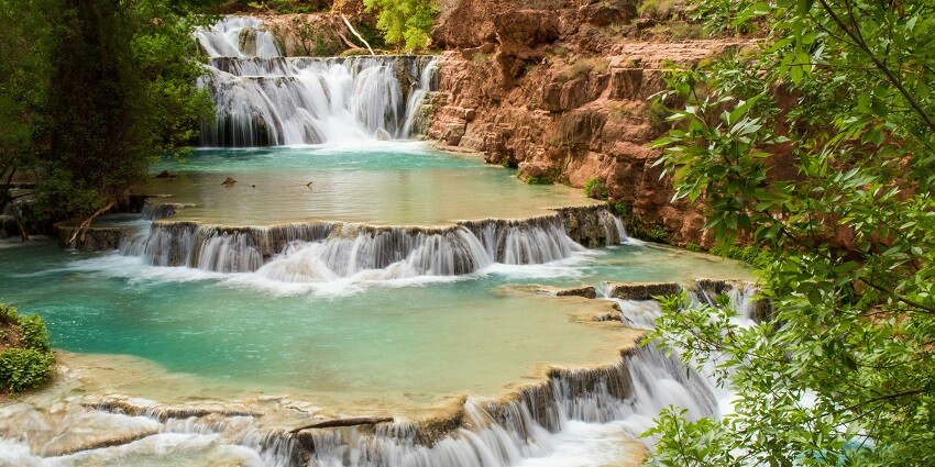 A glimpse of a sacred pool near the serene Akasha Ganga Waterfalls, a quaint hotspot.